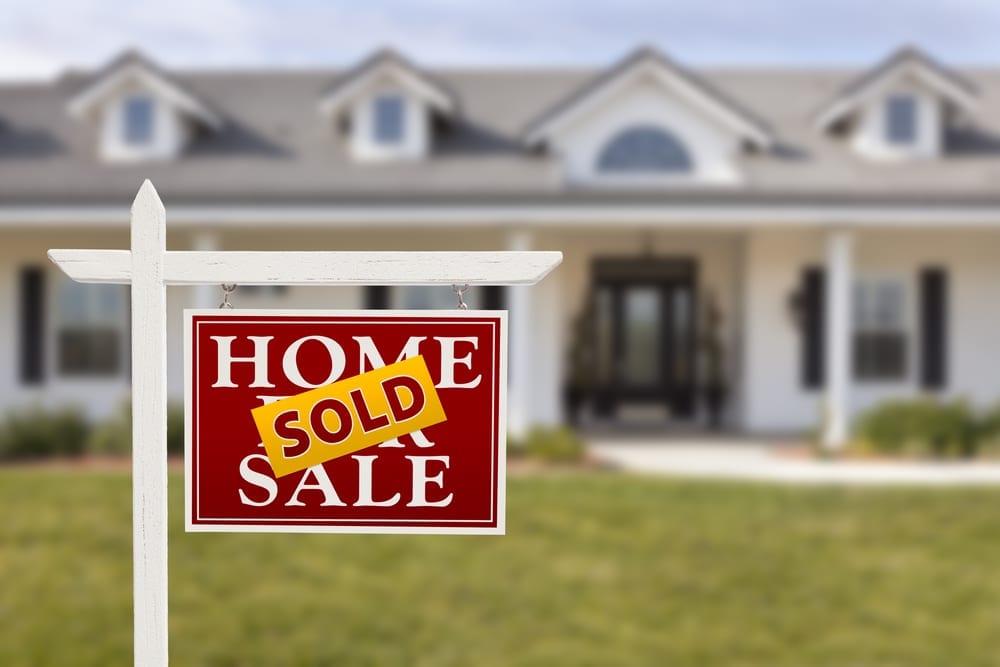 [home with sold sign in front]